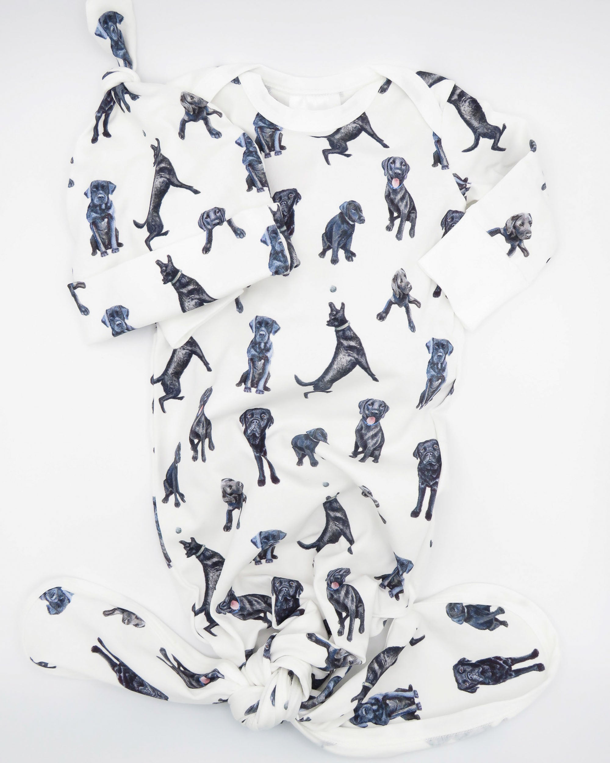 Black Labs pattern newborn gown and hat set displayed flat on a white background.