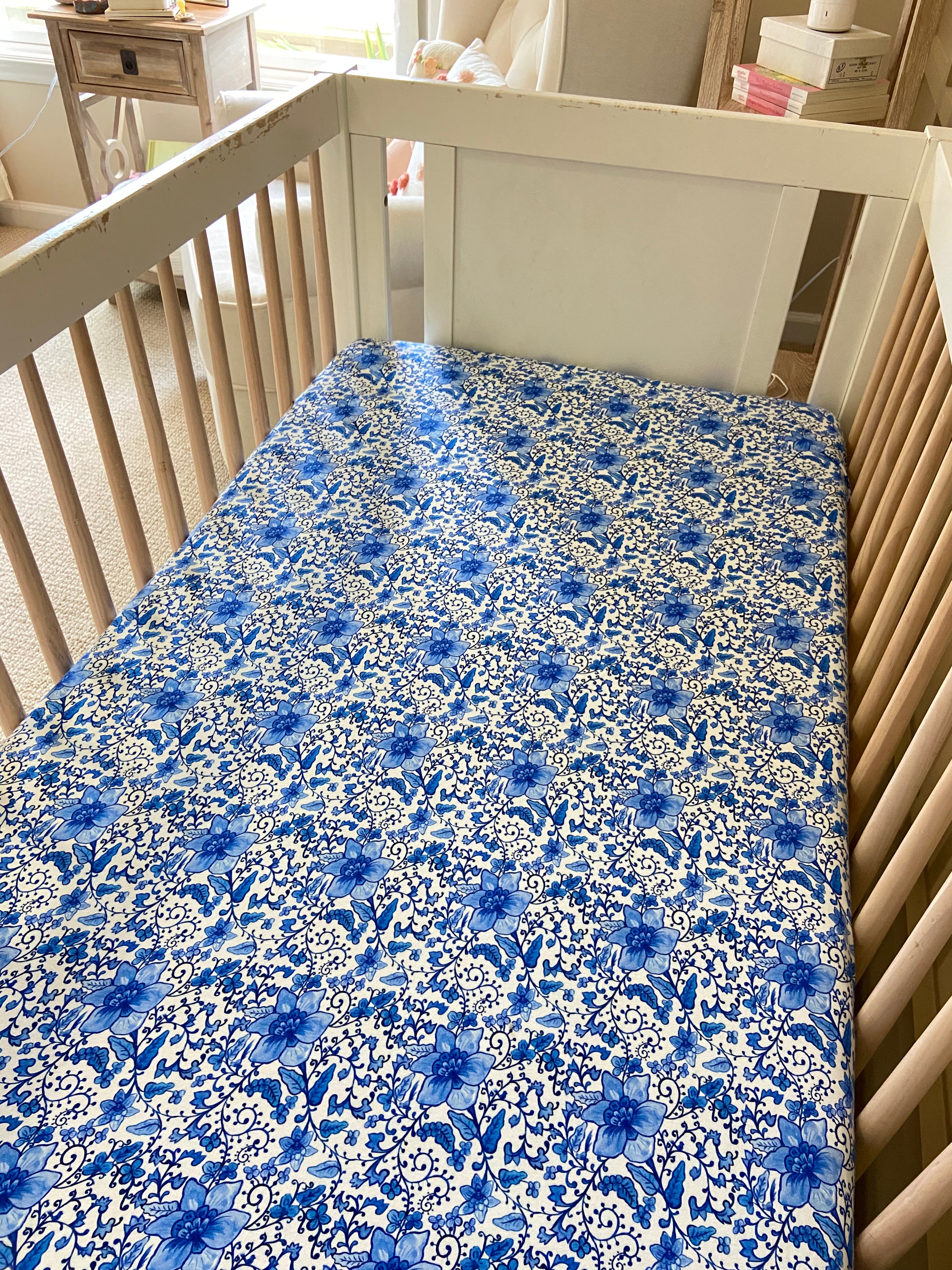 Soft cotton crib sheet with delicate chinoiserie design, perfect for a gender-neutral nursery