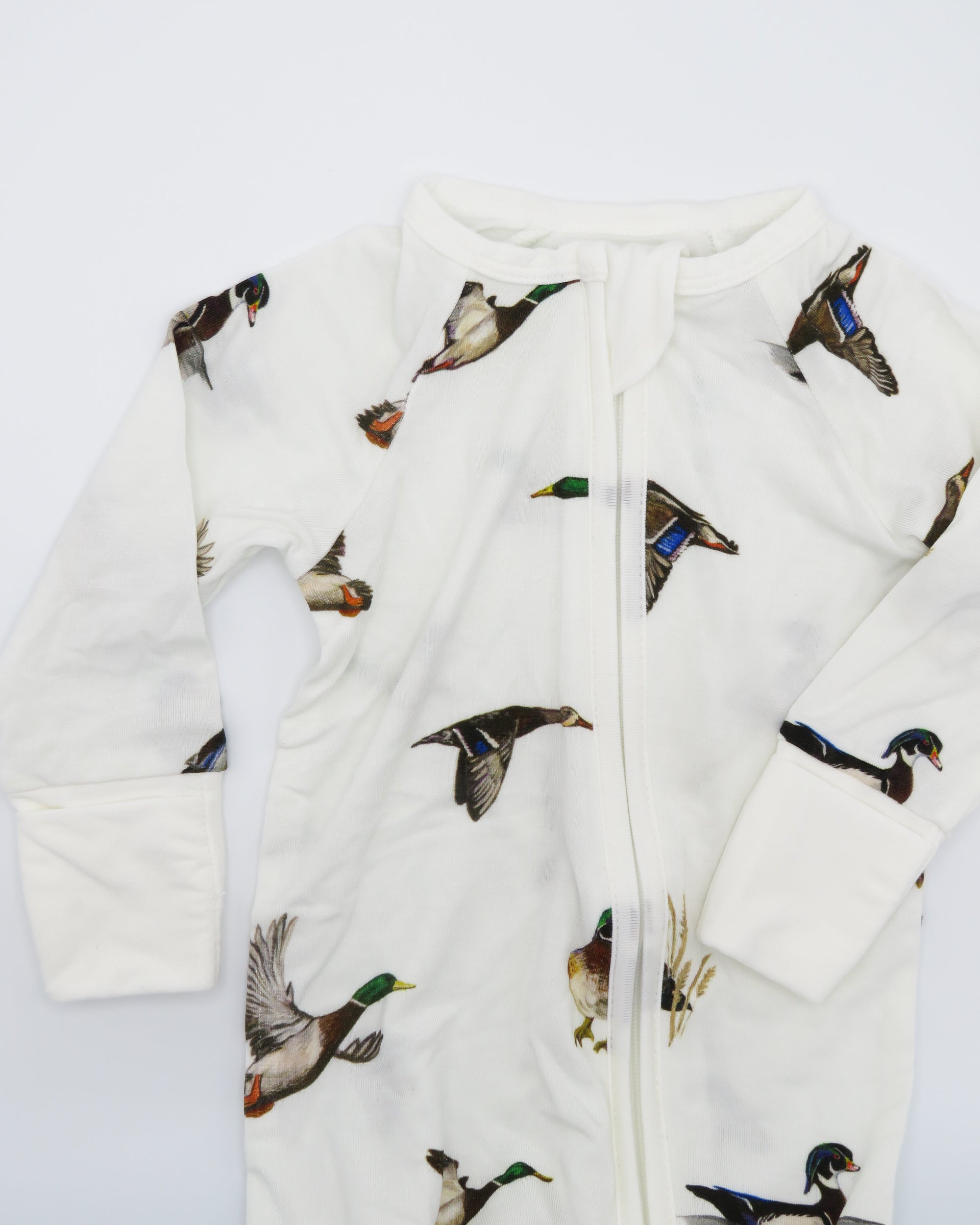 Diving Ducks convertible zip footies designed for easy dressing and comfort for infants. Printed on soft white fabric.