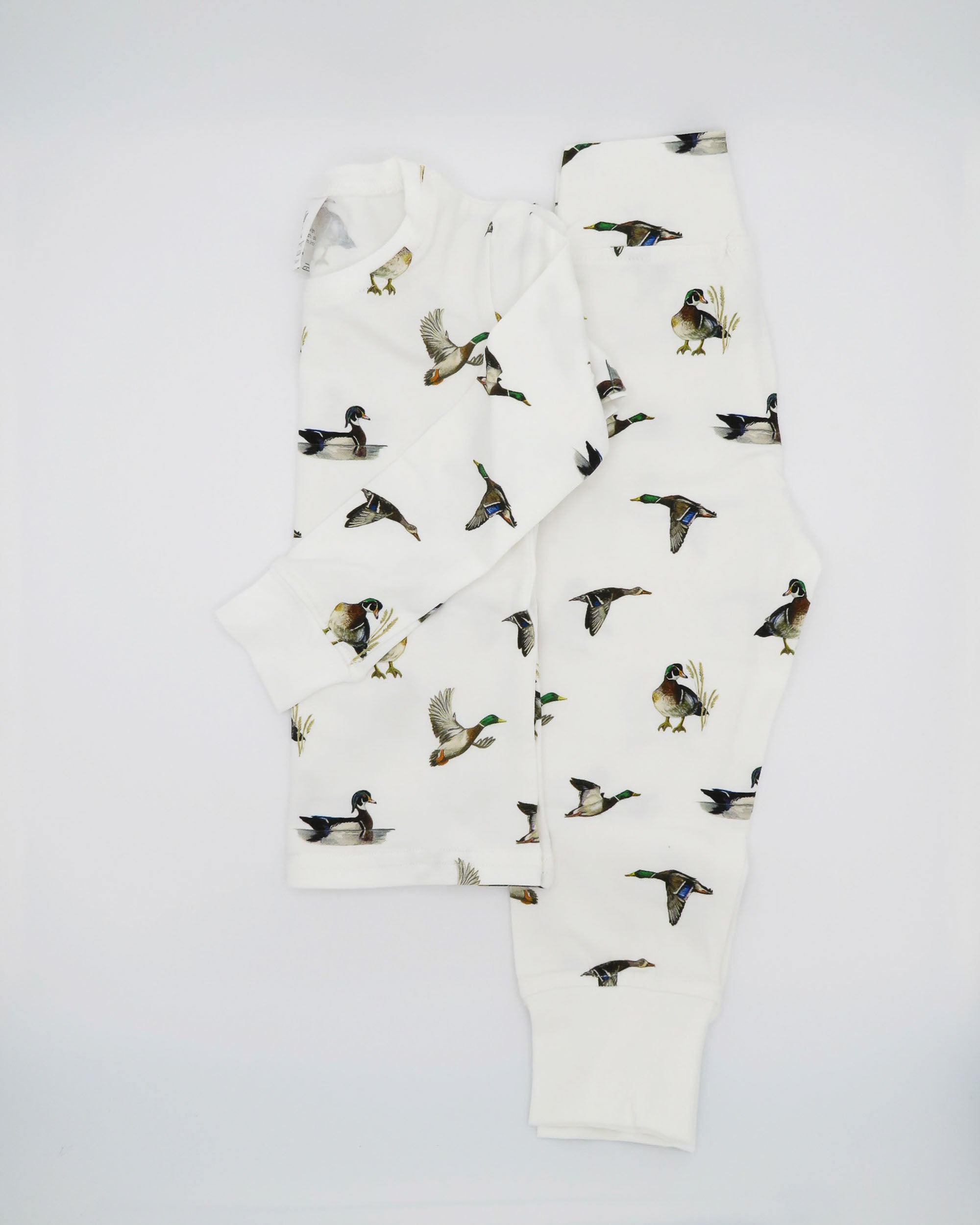 Unisex loungewear or sleepwear featuring a Diving Ducks print on soft white fabric. Kids’ pajamas flat image. Perfect for both indoor and outdoor wear.