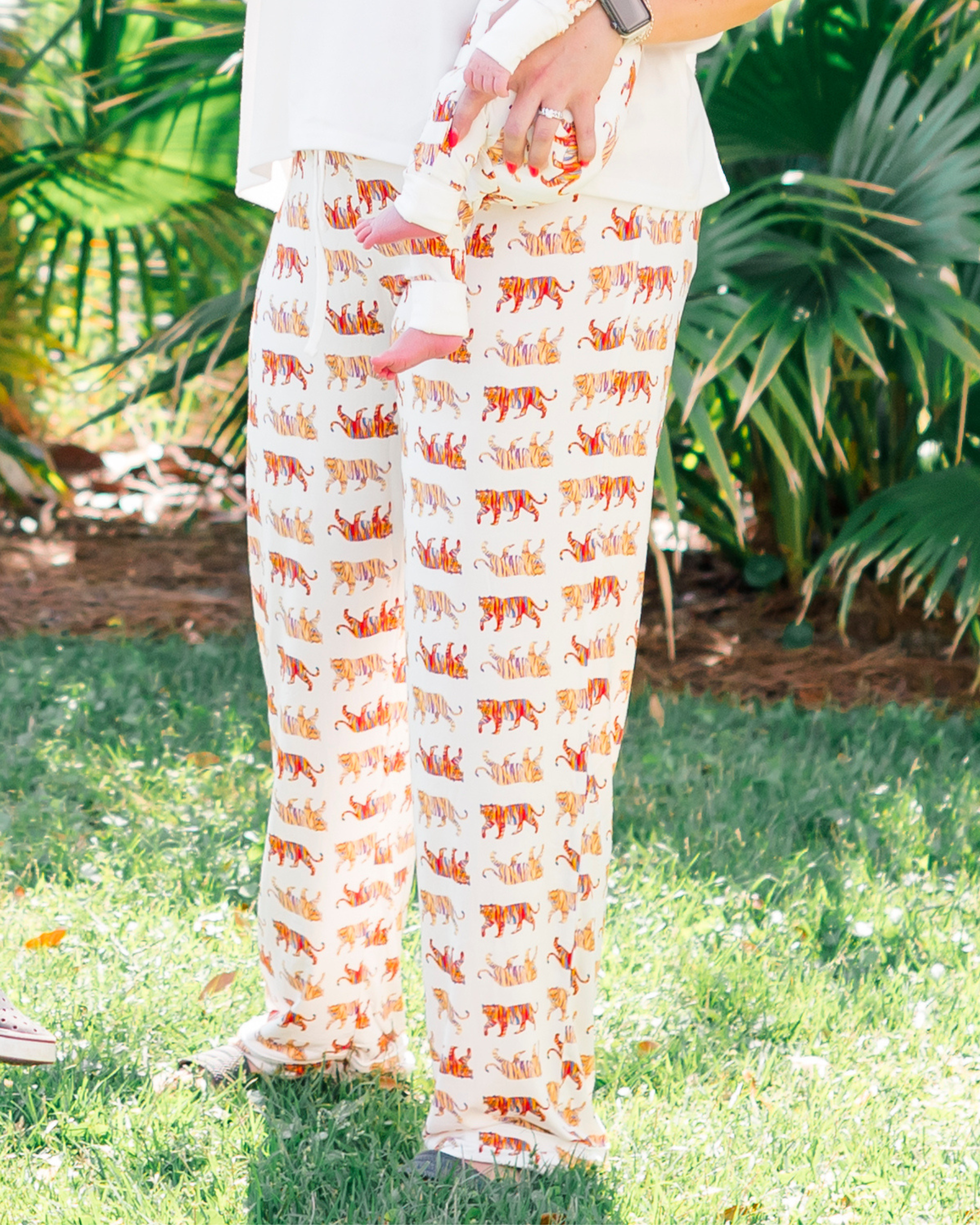 Soft white unisex Easy Tiger print pajama pants worn by a mom with her kids, matching family loungewear worn outdoors.