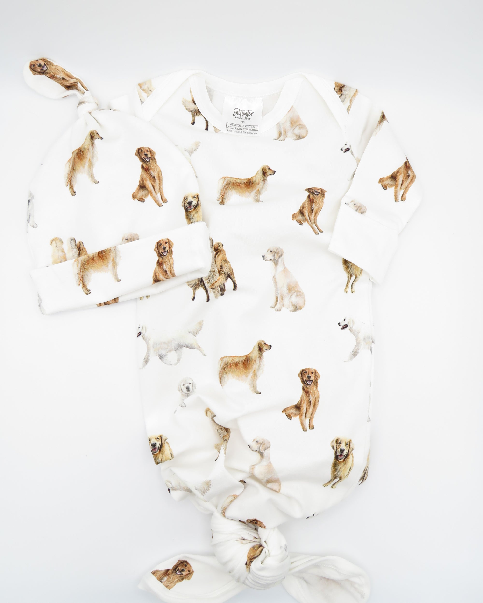 Golden Retriever print newborn gown with matching hat set, featuring Golden Retrievers printed on soft white fabric.