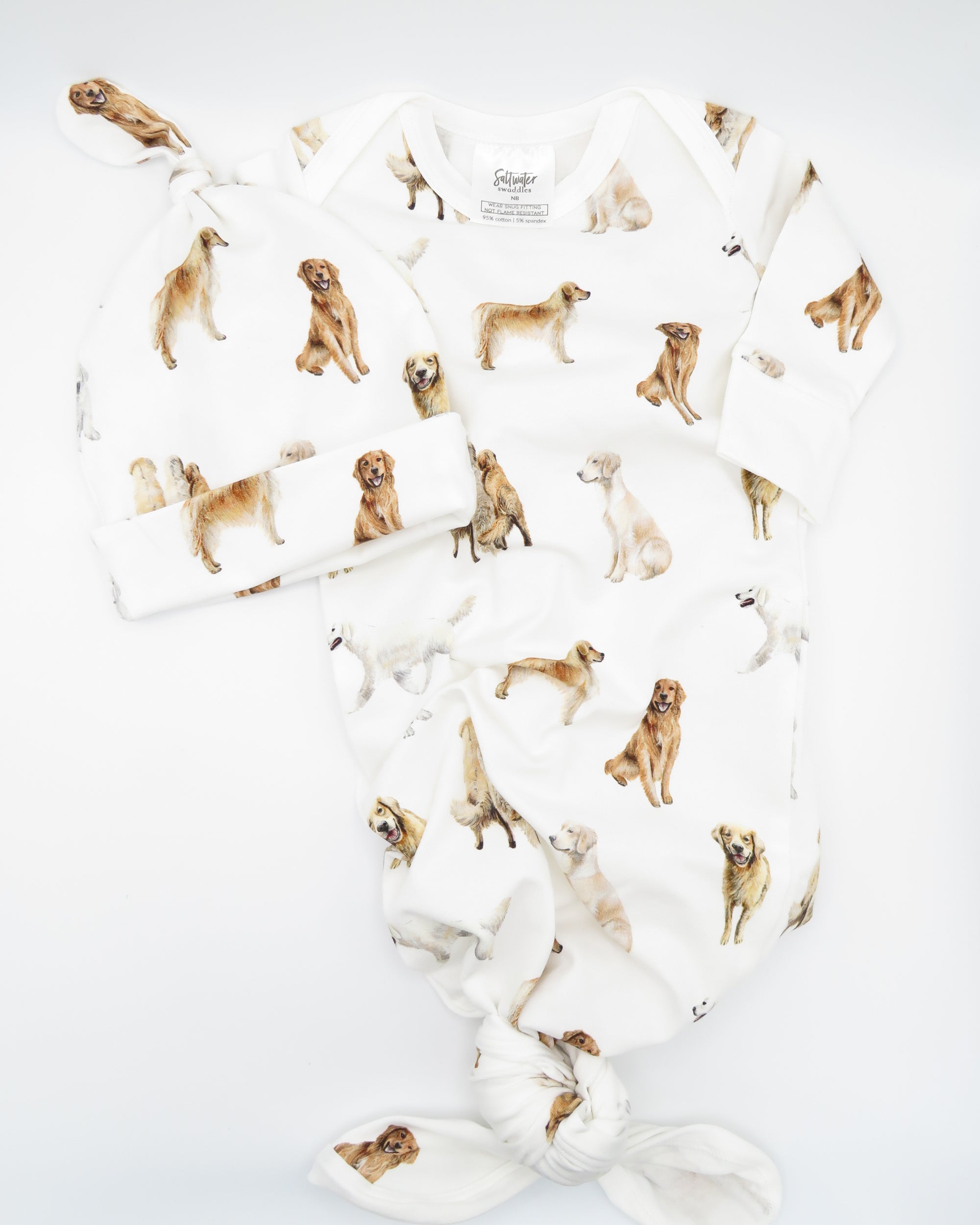 Golden Retriever print newborn gown with matching hat set, featuring Golden Retrievers printed on soft white fabric.