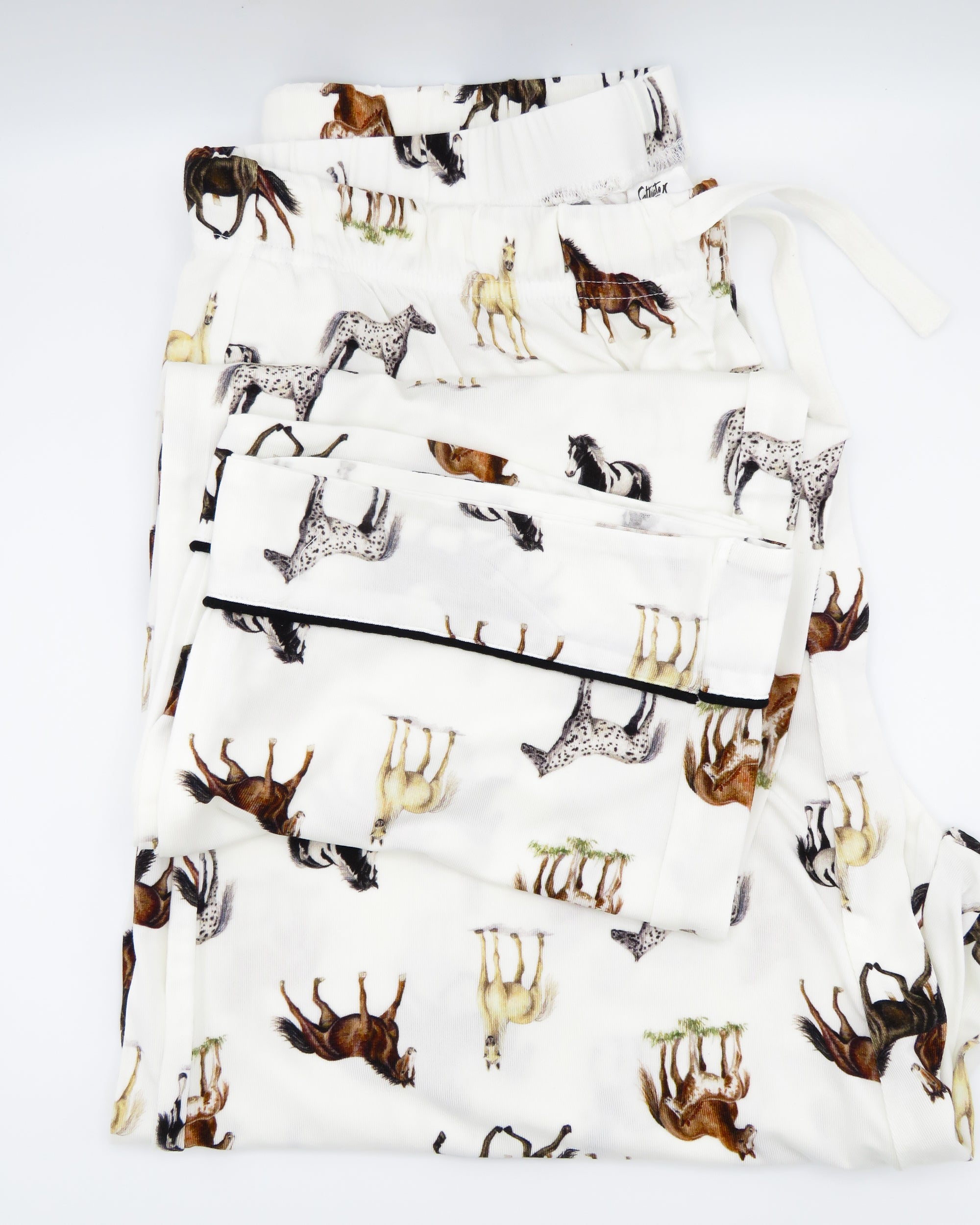 Adult unisex pajama pants with favorite harbor horse print, made of soft white bamboo-spandex blend, featuring elastic waistband with drawstring, pockets, and piping on hems, perfect for lounging or bedtime.