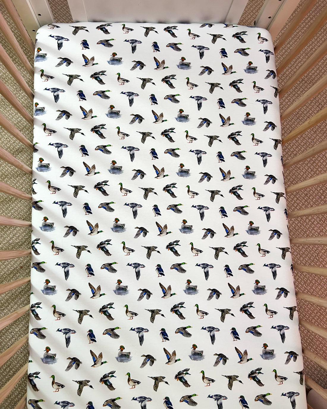 Adorable duck pattern crib sheet in soft colors, great for a gender-neutral duck-themed nursery.