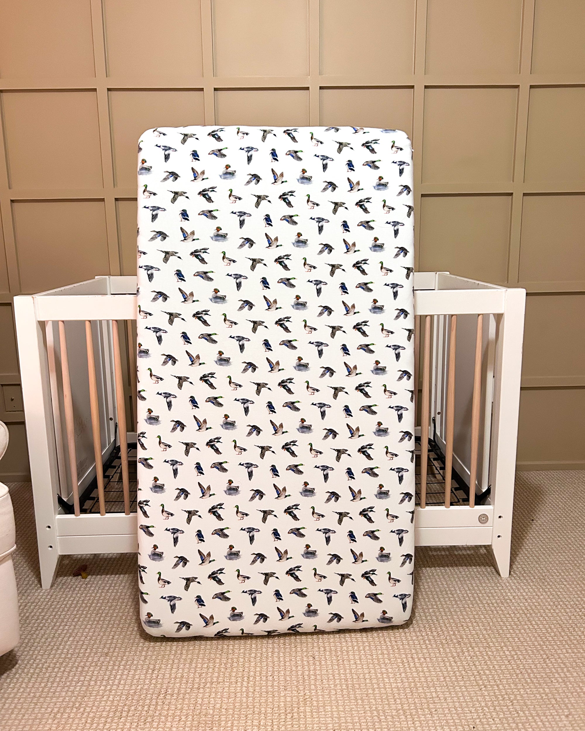Adorable duck pattern crib sheet in soft colors, great for a gender-neutral duck-themed nursery.