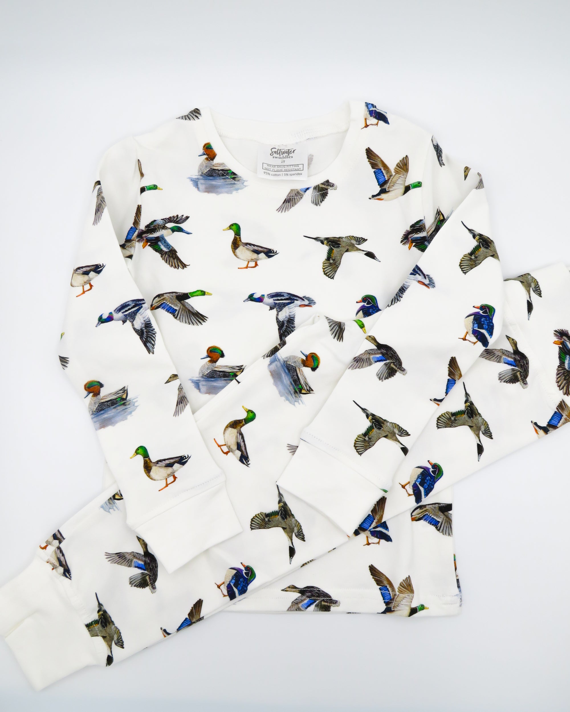 Two-piece duck print pajama set for kids made from soft, breathable fabric.
