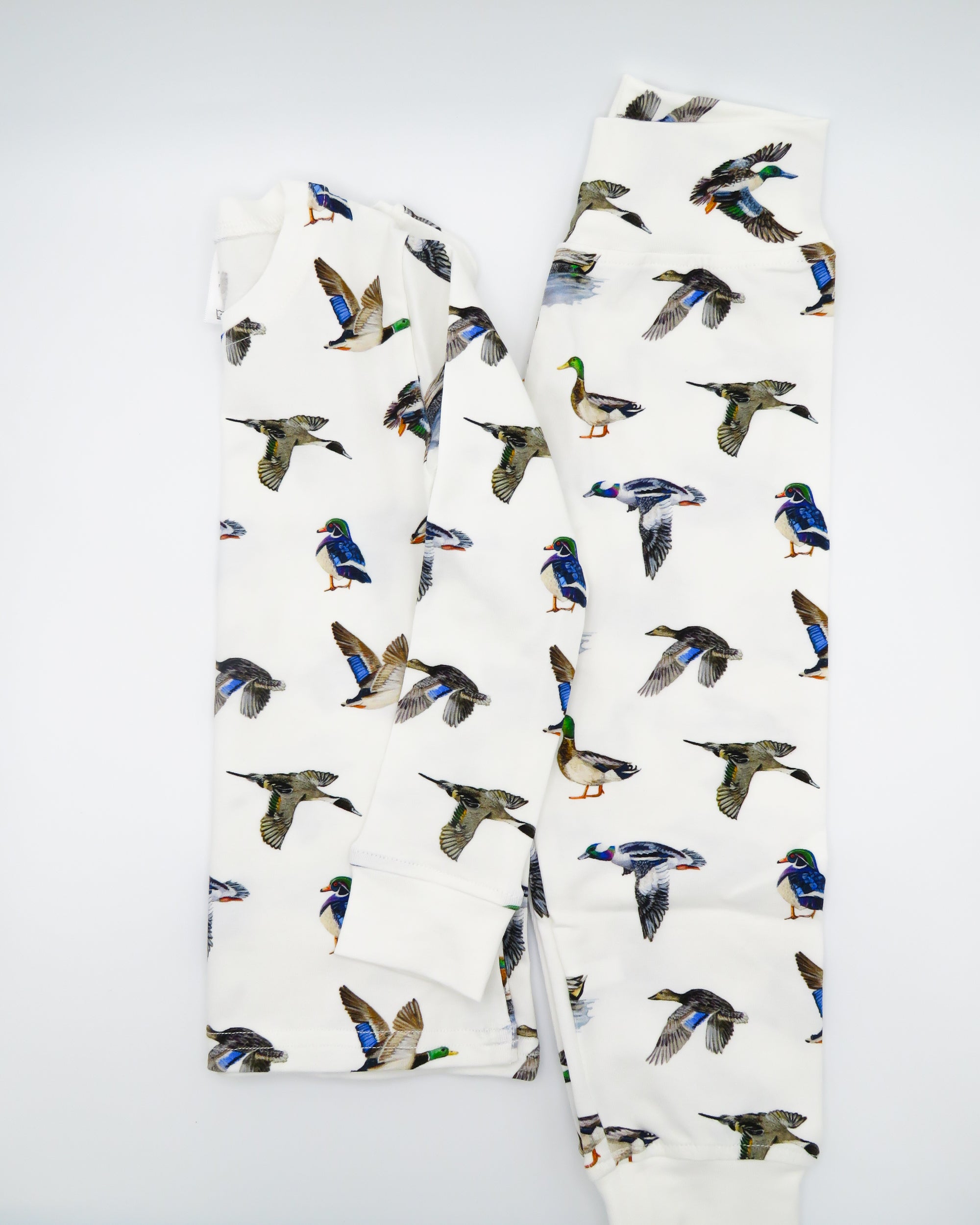 Two-piece duck print pajama set for kids made from soft, breathable fabric.