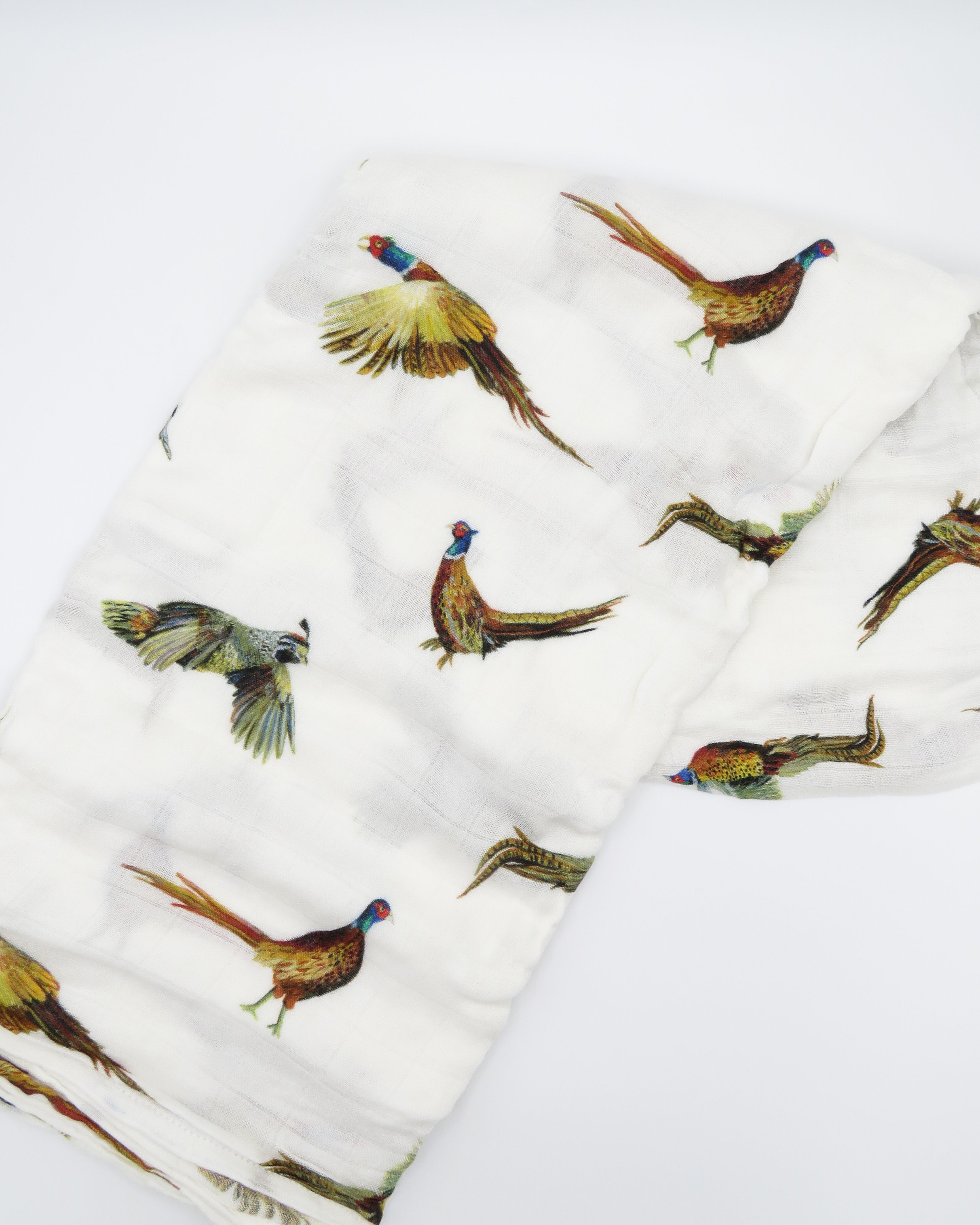 Pheasant and Quail Print Baby Swaddle – Vibrant nature-inspired design made from organic white cotton and bamboo, cozy and soft, folded and displayed flat on a white background.