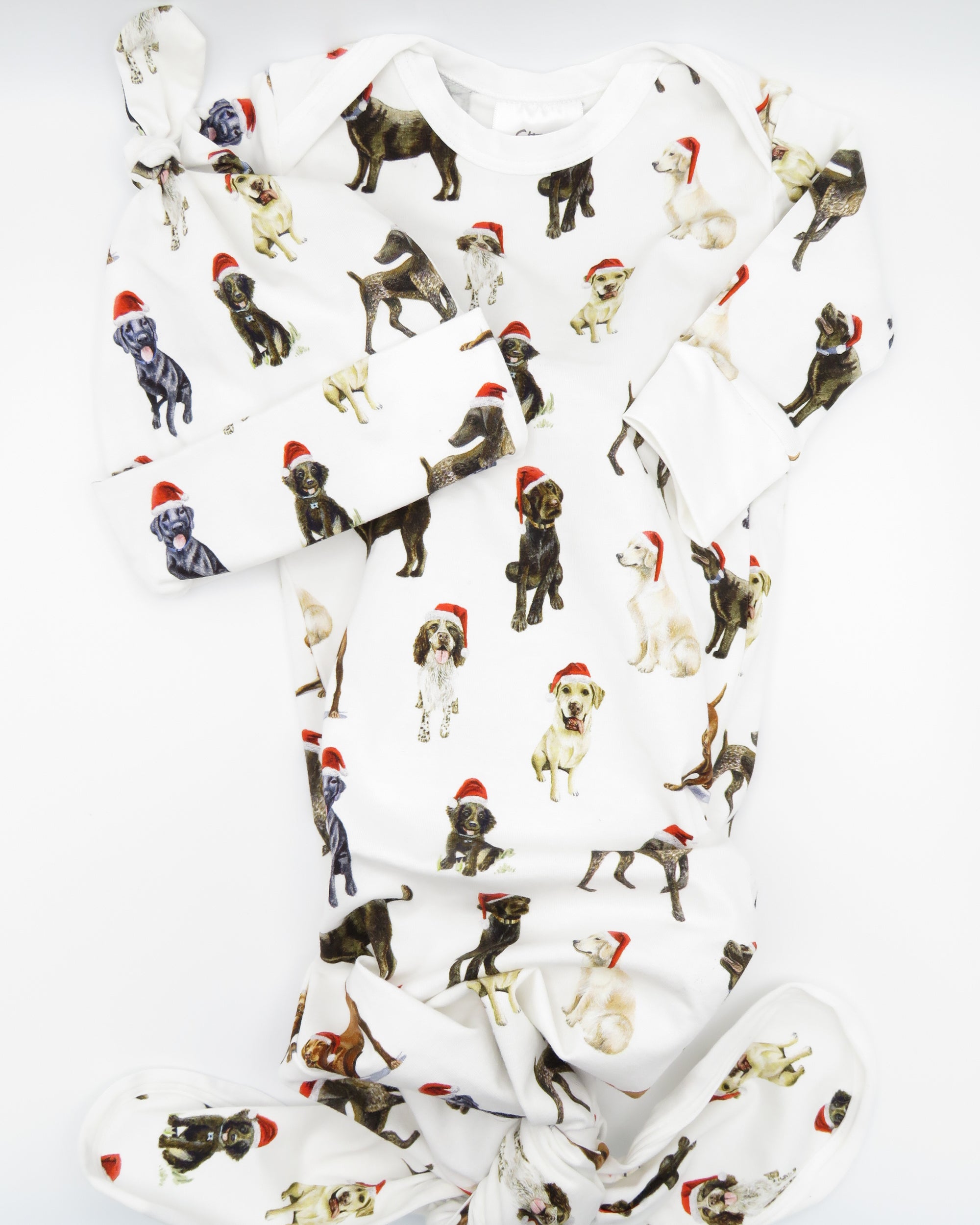 Comfy newborn gown and hat set featuring cute Santa dog prints, perfect for baby’s first Christmas