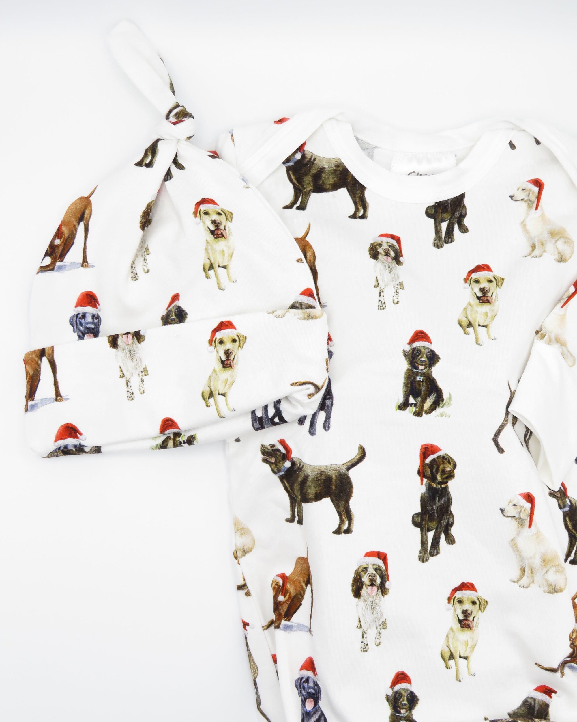 Comfy newborn gown and hat set featuring cute Santa dog prints, perfect for baby’s first Christmas