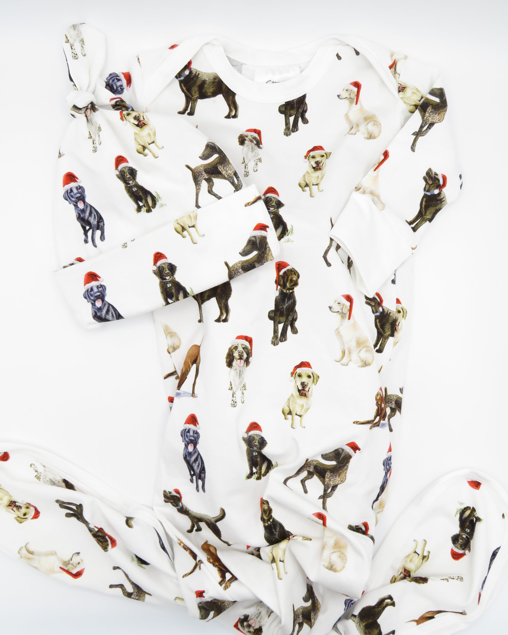 Comfy newborn gown and hat set featuring cute Santa dog prints, perfect for baby’s first Christmas