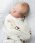 A newborn swaddled in a blanket with bulldog patterns.