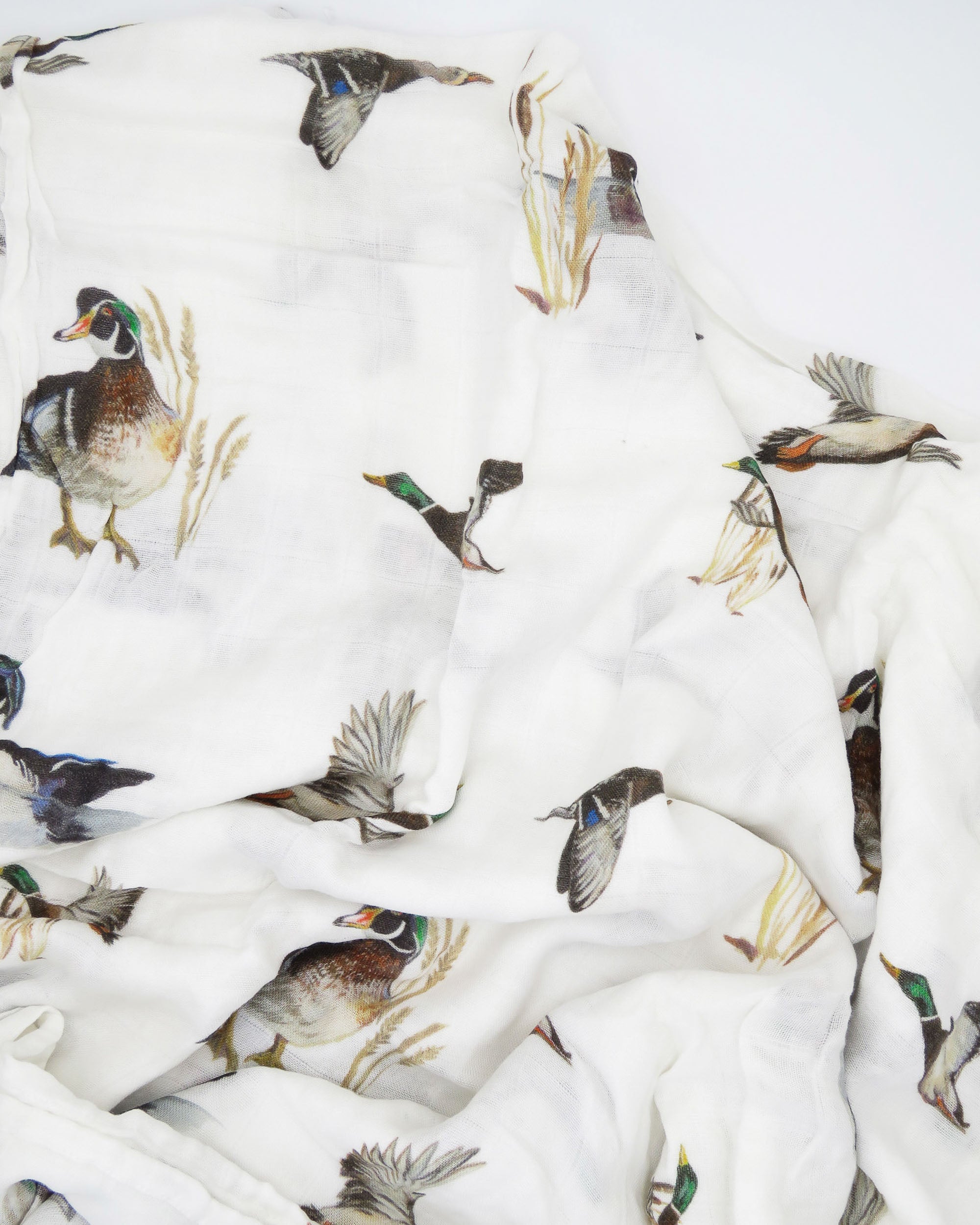 Vibrant watercolor pattern of diving ducks on a soft swaddle, perfect for wrapping newborns in style and comfort