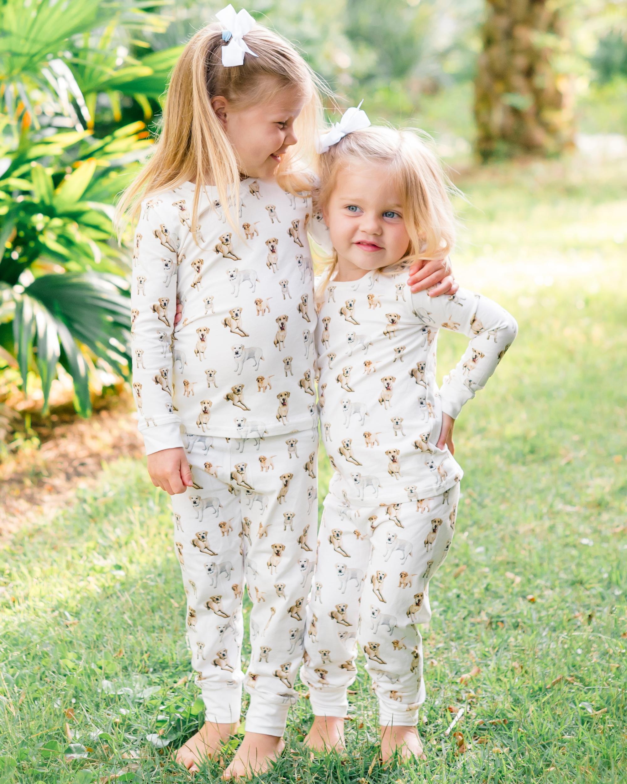Yellow Labrador print kids pajamas set for bedtime - Sleepwear or loungewear worn by two kids outdoors.