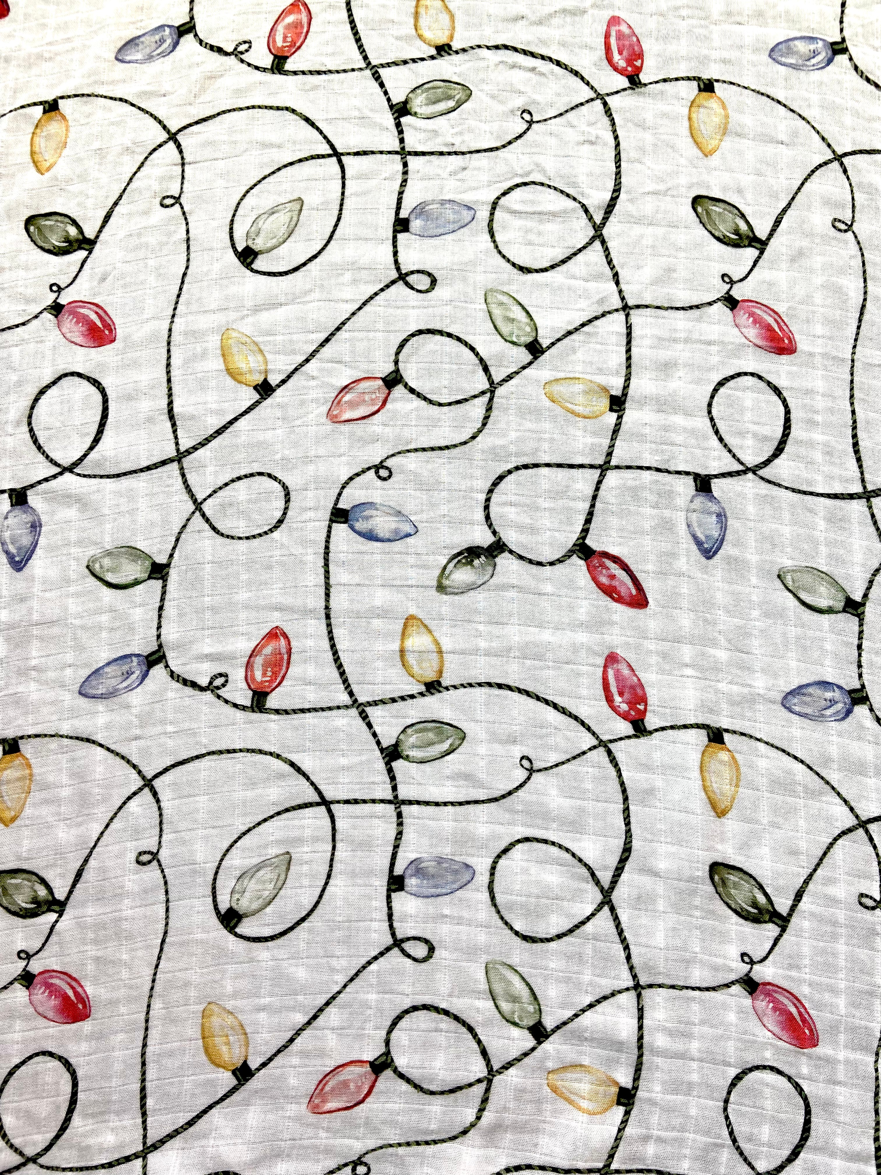 Christmas swaddle with a vintage Christmas lights pattern.
