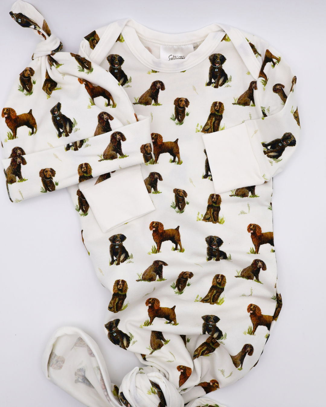 Soft Beaufort Boykins newborn gown and hat set, displayed flat on a white background.