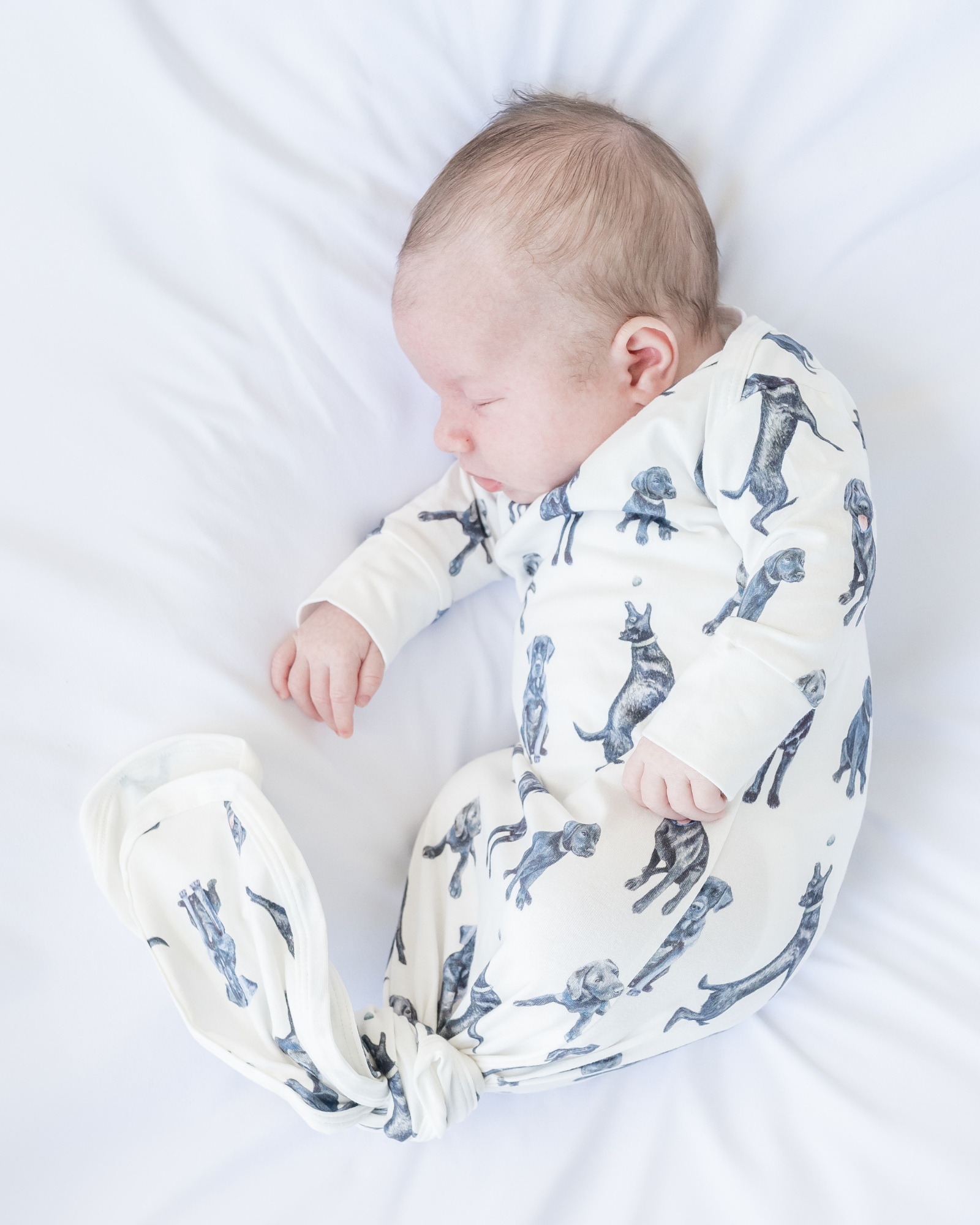 Newborn gown and matching hat featuring a whimsical Black Labs print, perfect for baby showers and dog-loving parents