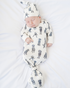 Newborn gown and matching hat featuring a whimsical Black Labs print, perfect for baby showers and dog-loving parents