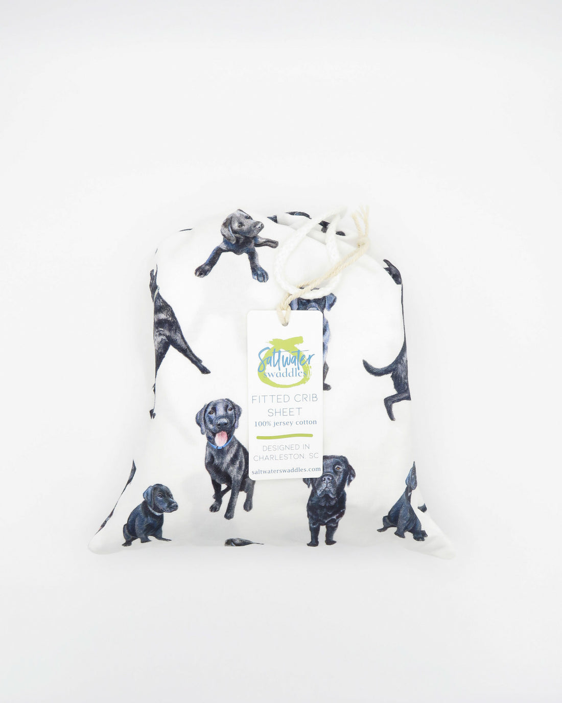 Fitted Black Lab crib sheet featuring adorable Black Labrador designs, crafted for durability and softness, printed on gentle white fabric—perfect for both cribs and toddler beds.