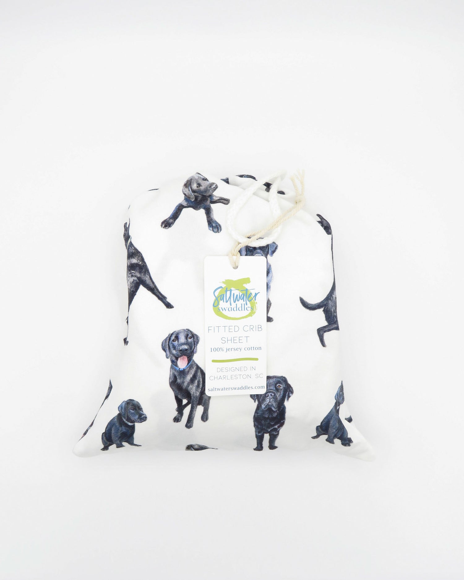 Fitted Black Lab crib sheet featuring adorable Black Labrador designs, crafted for durability and softness, printed on gentle white fabric—perfect for both cribs and toddler beds.