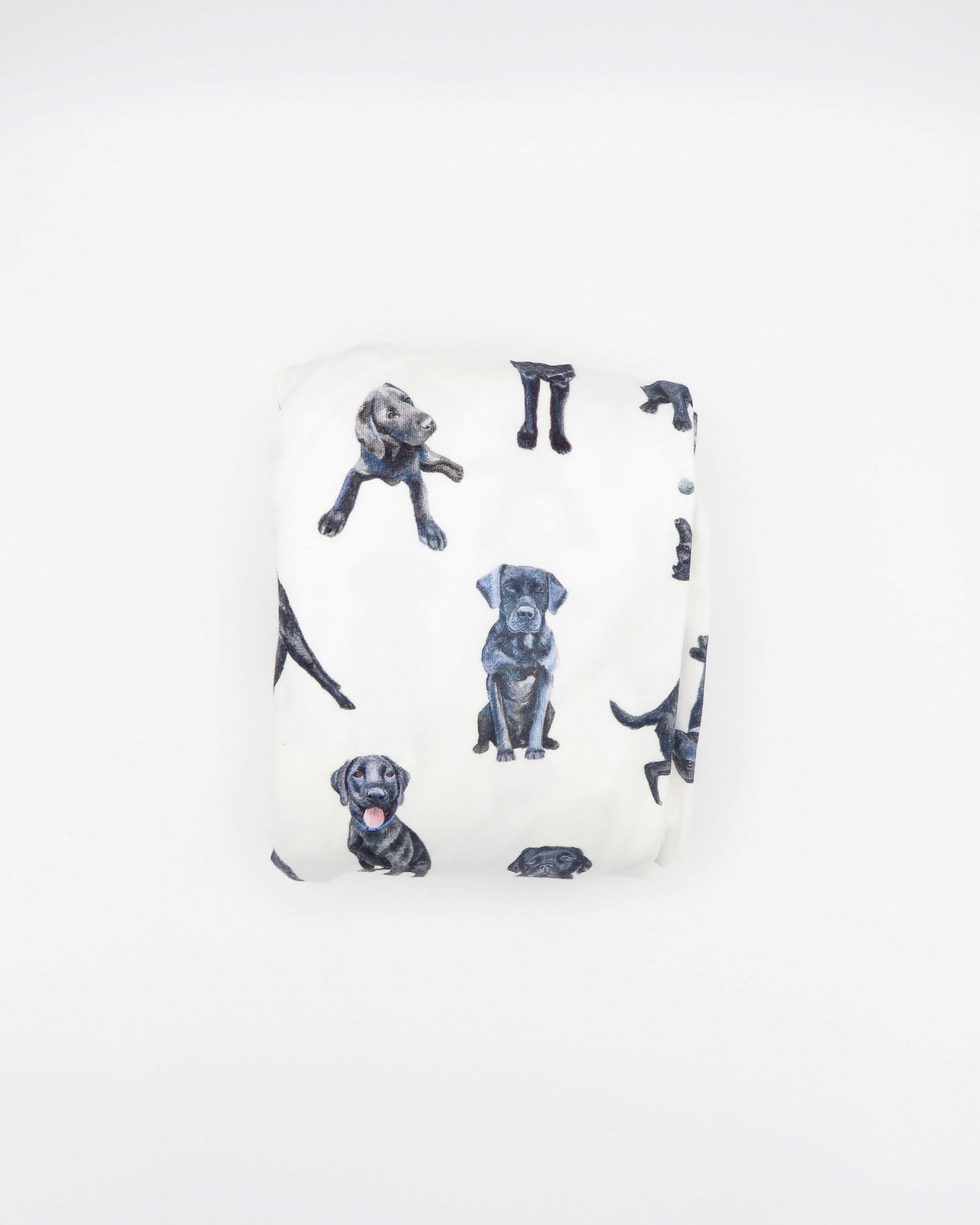 Fitted Black Lab crib sheet featuring adorable Black Labrador designs, crafted for durability and softness, printed on gentle white fabric—perfect for both cribs and toddler beds.
