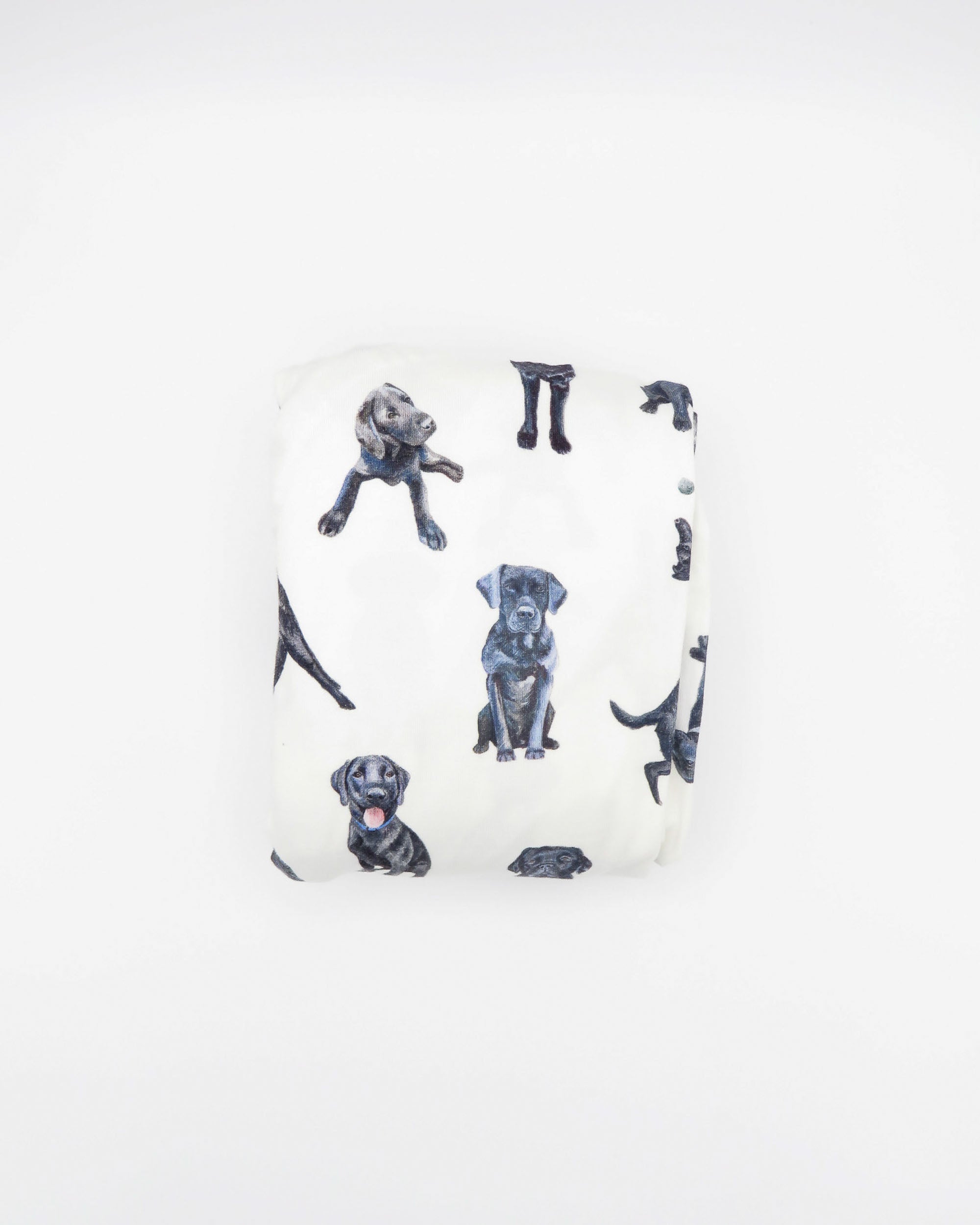 Fitted Black Lab crib sheet featuring adorable Black Labrador designs, crafted for durability and softness, printed on gentle white fabric—perfect for both cribs and toddler beds.