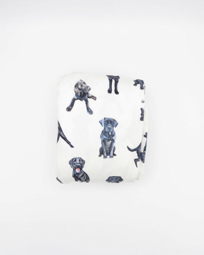 Fitted Black Lab crib sheet featuring adorable Black Labrador designs, crafted for durability and softness, printed on gentle white fabric—perfect for both cribs and toddler beds.