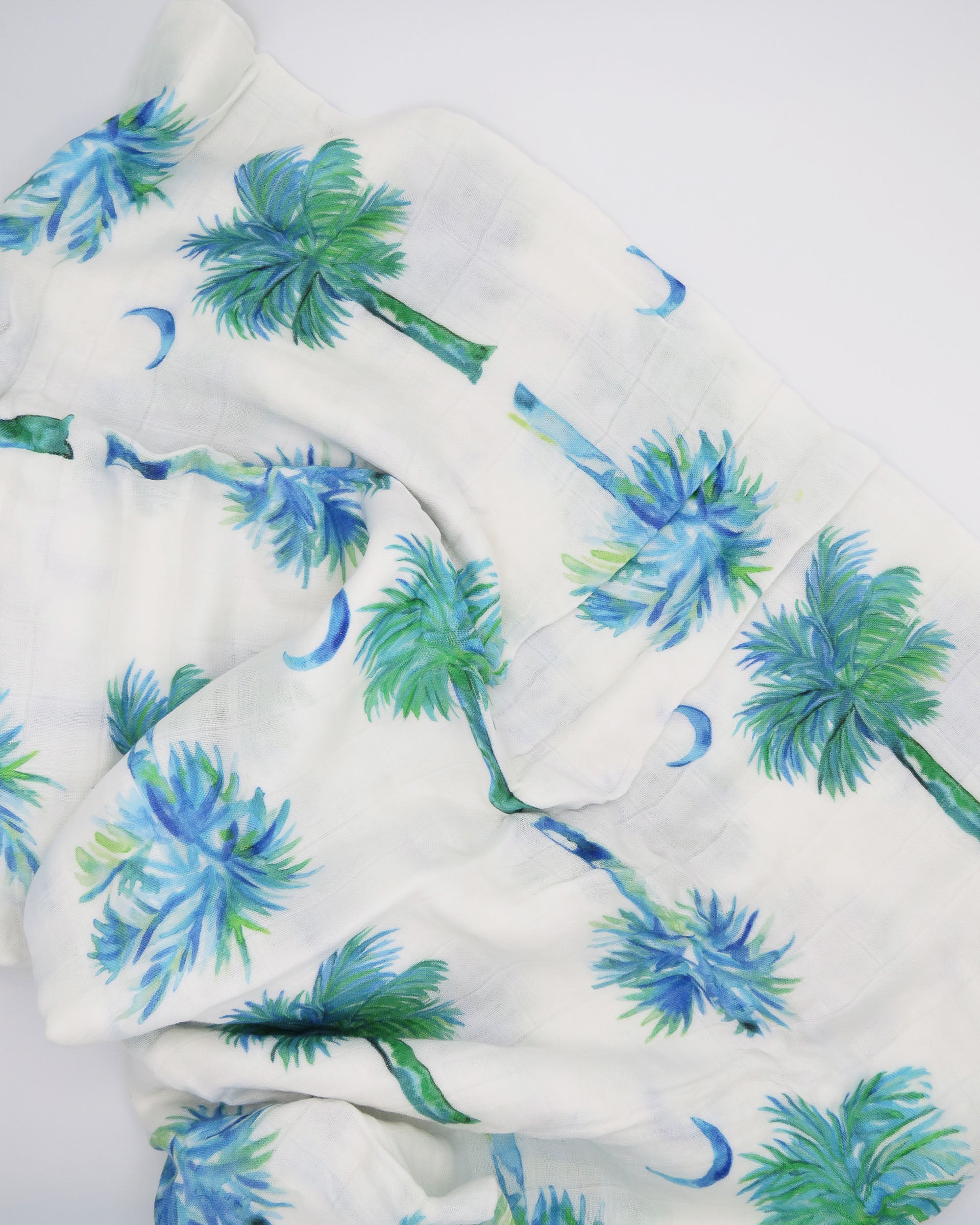 Blue Palmettos Print Baby Swaddle with Watercolor Palmetto Trees Design. blue palmettos hand-painted and printed on soft white fabric. 
