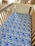 Soft cotton crib sheet with delicate chinoiserie design, perfect for a gender-neutral nursery