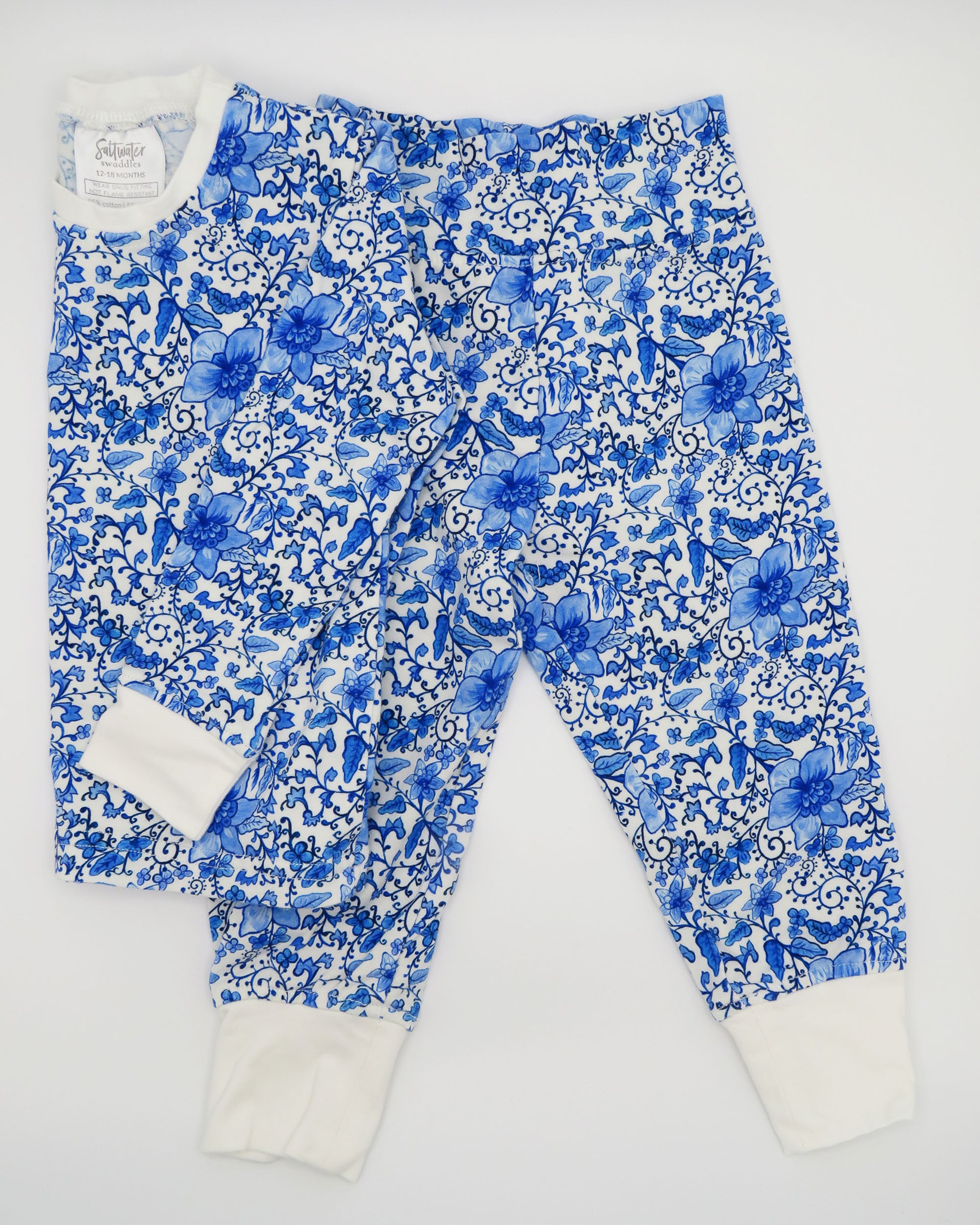Charming Chinoiserie pajamas in soft white cotton, suitable for indoor or outdoor wear, displayed on a white background.