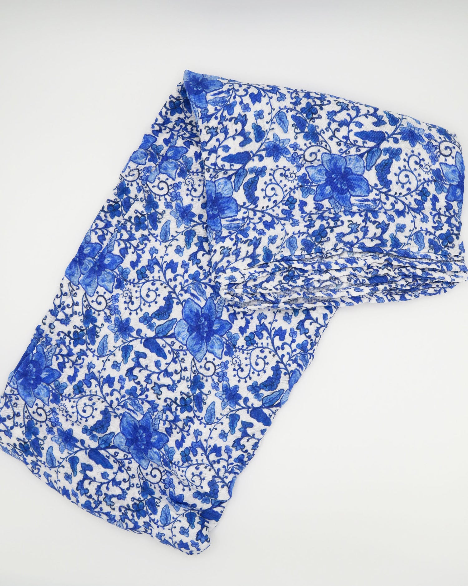 Charming newborn gown and matching hat featuring a timeless Chinoiserie print on soft white fabric, perfect for special newborn moments.