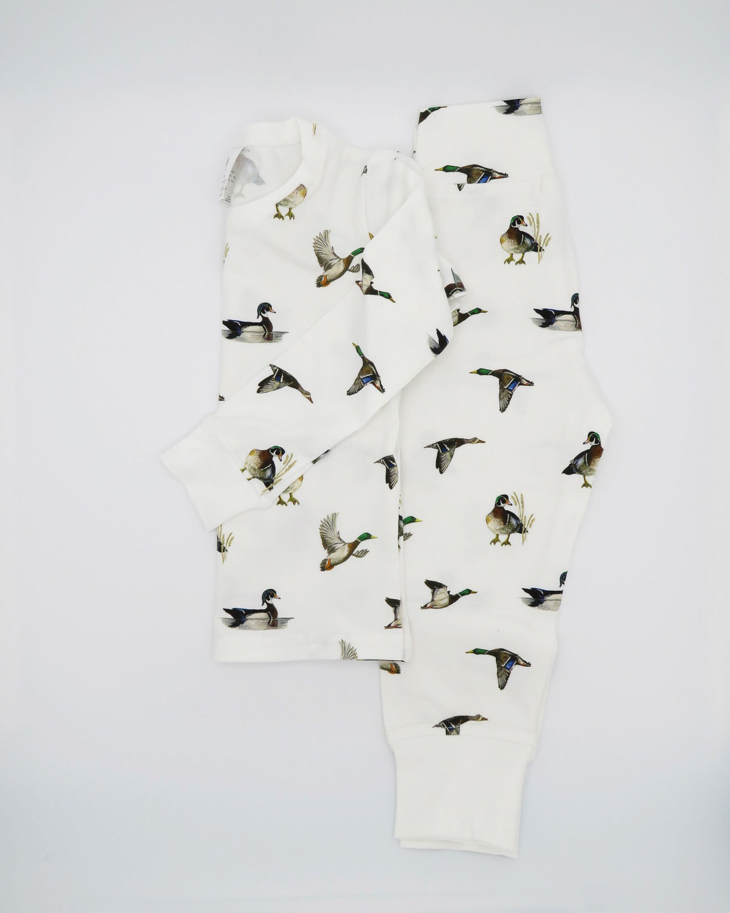 Unisex loungewear or sleepwear featuring a Diving Ducks print on soft white fabric. Kids’ pajamas flat image. Perfect for both indoor and outdoor wear.