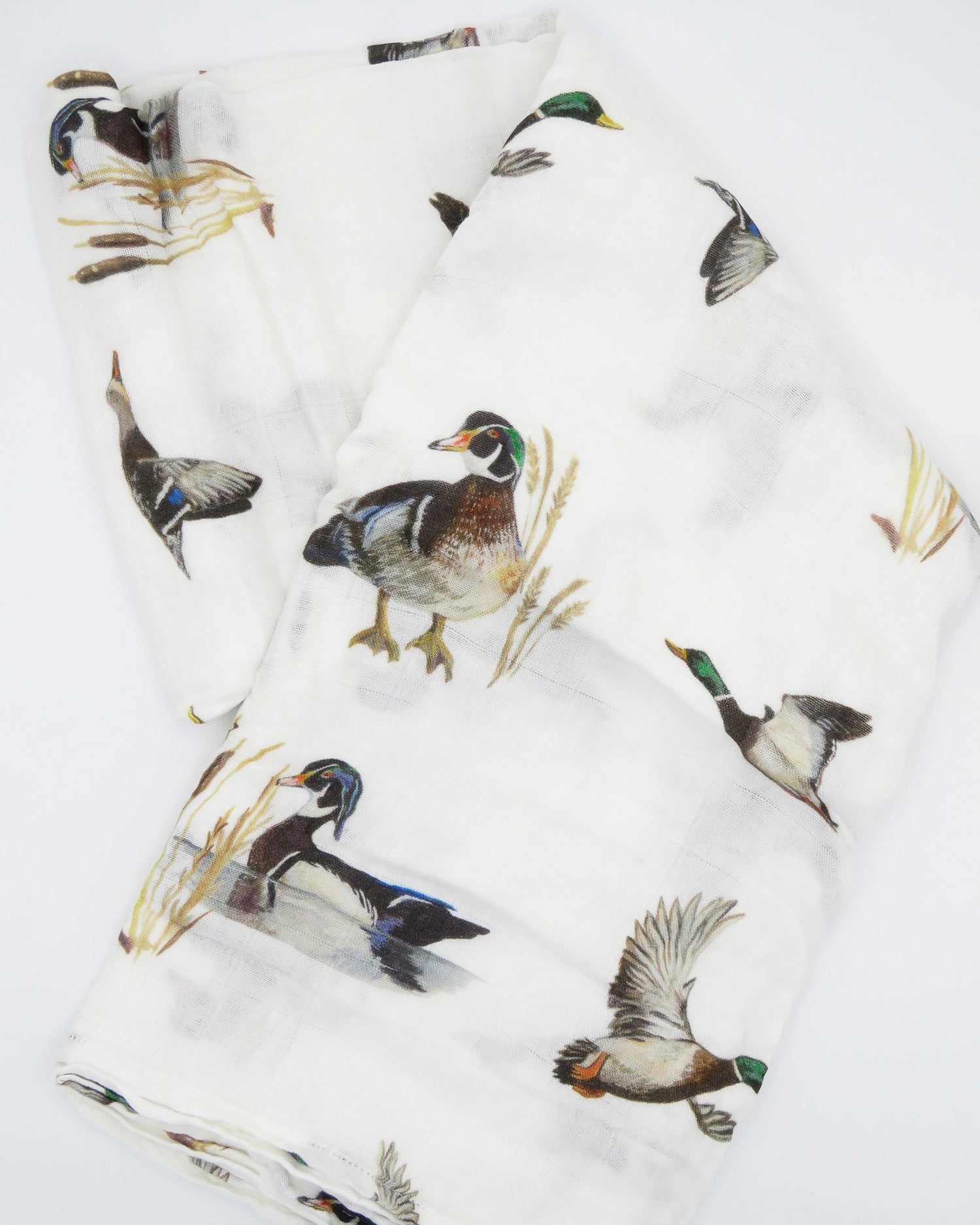 Vibrant watercolor diving ducks pattern swaddle, perfect for wrapping newborns in style and comfort. The soft white fabric features an adorable diving ducks print. Your baby will look precious wrapped in this cute swaddle, ideal for those first special moments and a thoughtful addition to the hospital bag.