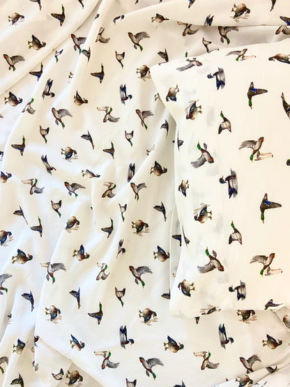 Close-up of diving ducks design on soft, high-quality bed sheets.