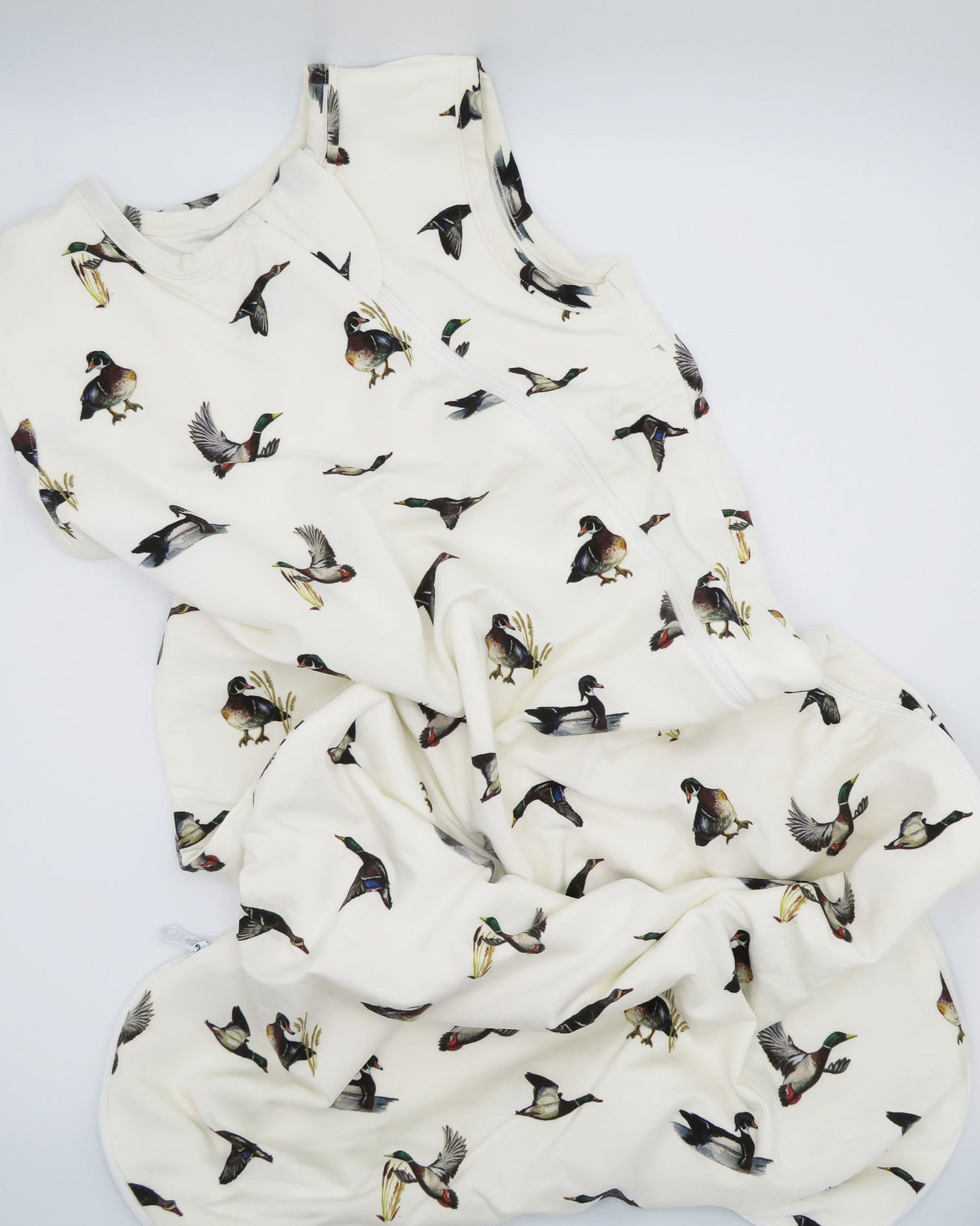 Baby white sleep sack featuring a charming diving ducks print, perfect for cozy nighttime snuggles.
