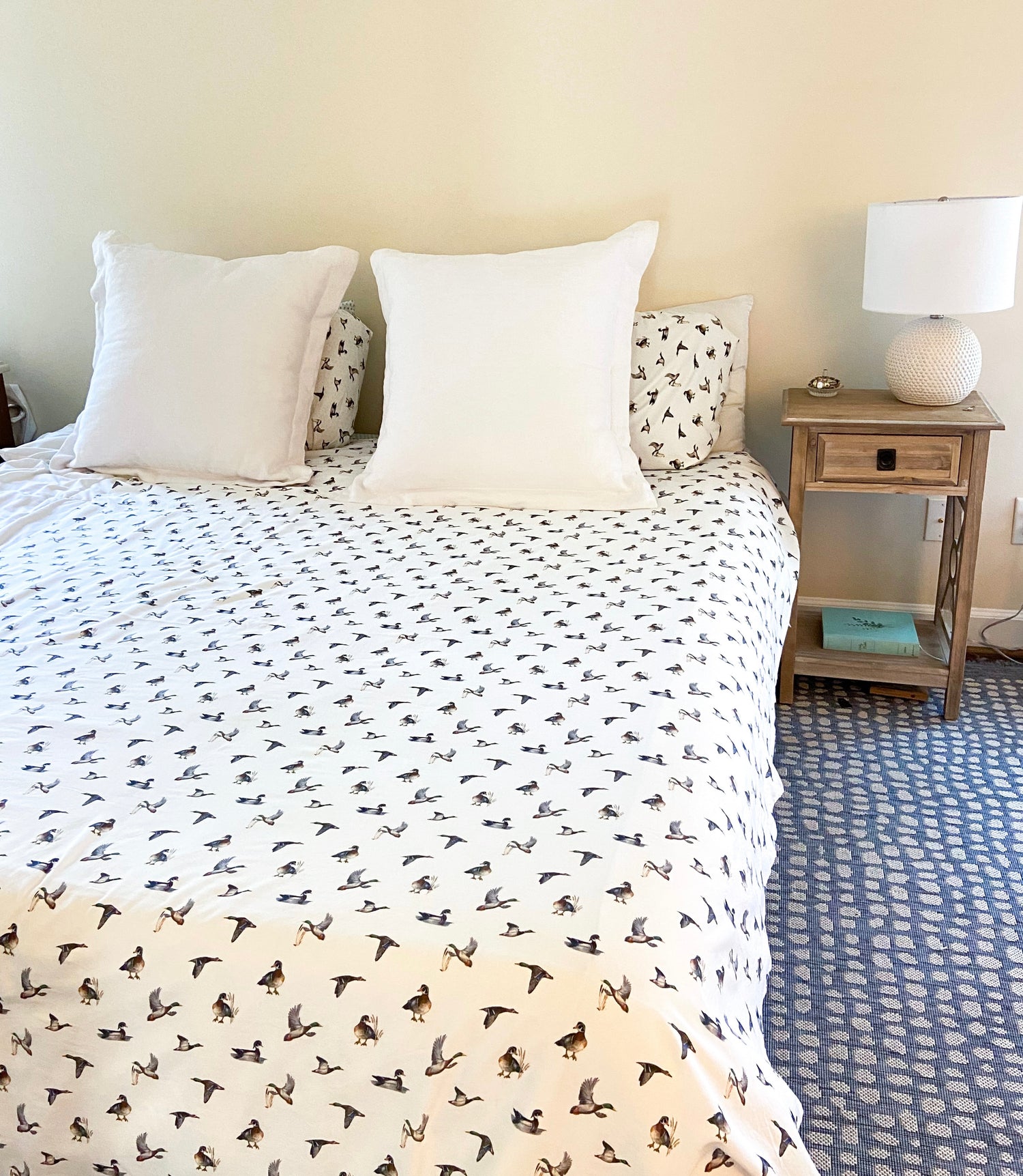 Diving ducks duvet cover on a bed. Printed on soft white fabric