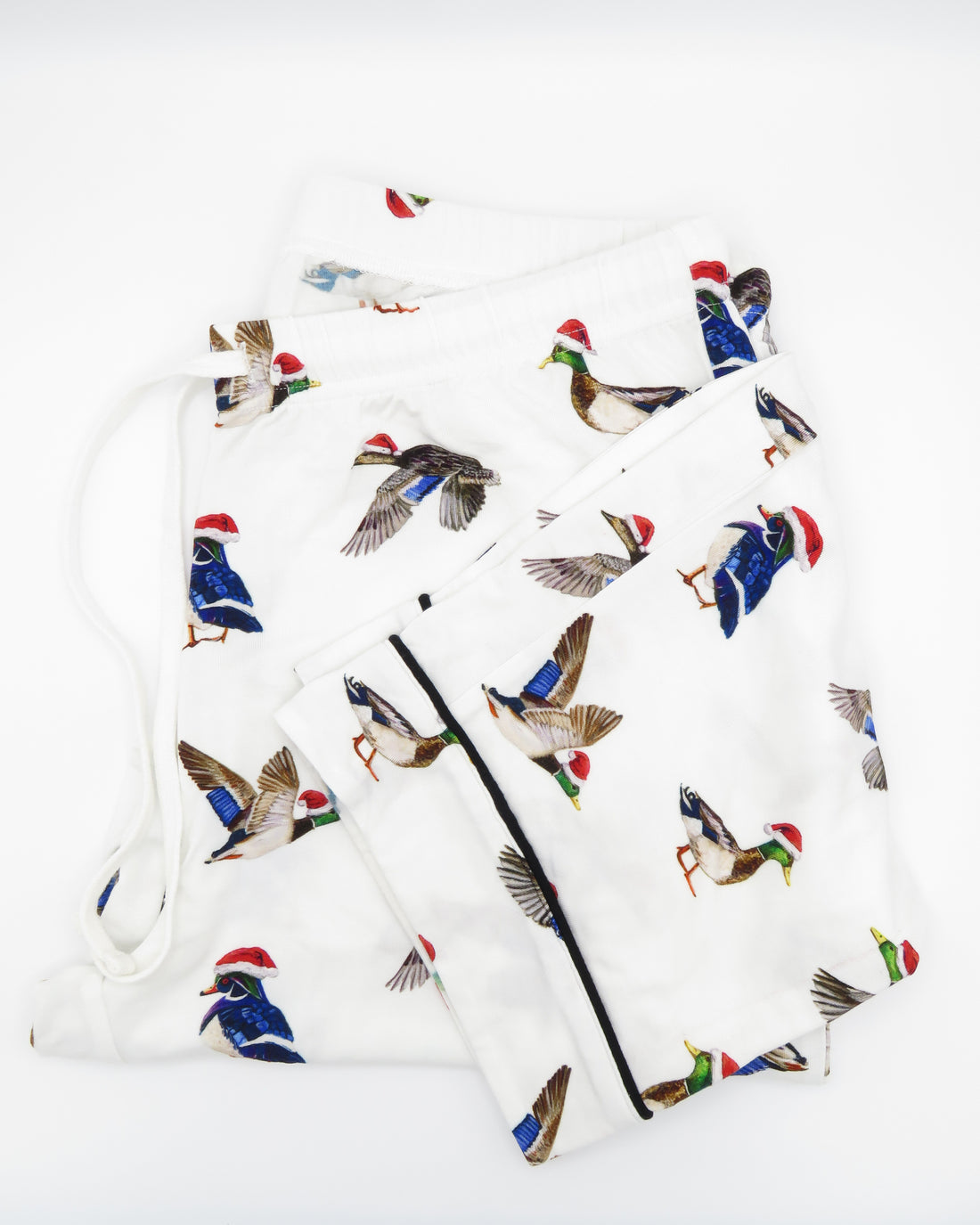 A pair of adult-sized pajama pants with a holiday pattern featuring duck the halls.