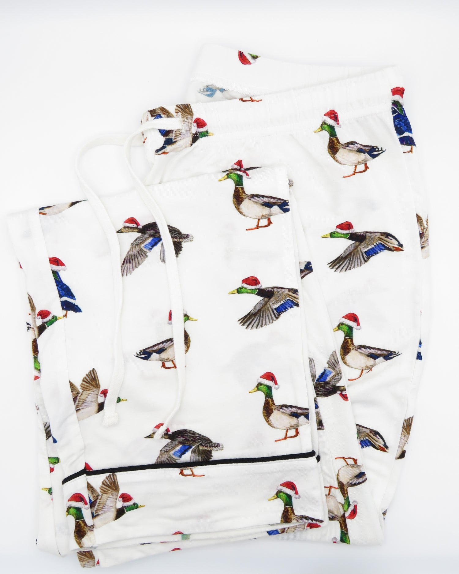 A pair of adult-sized pajama pants with a holiday pattern featuring duck the halls.