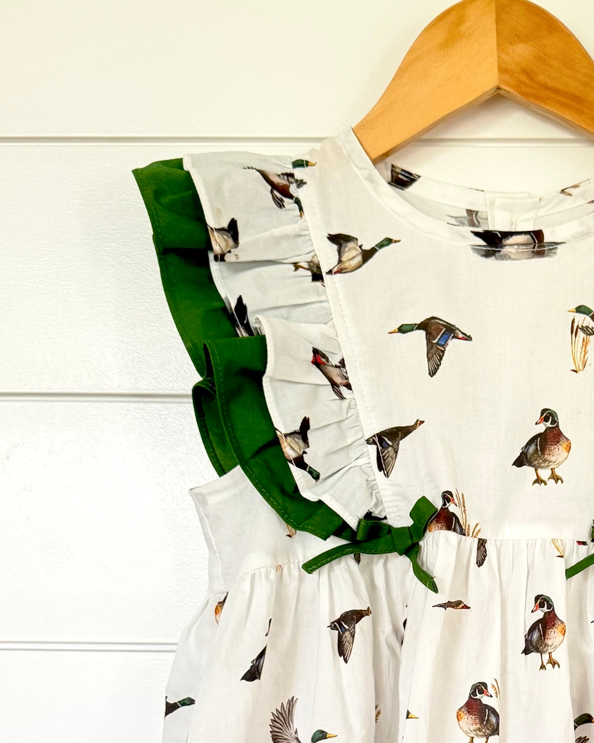 Close up of Diving Ducks flutter dress printed on soft white fabric. Perfect for indoors and outdoors.