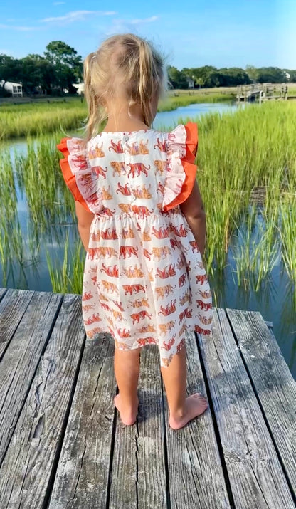 Easy Tiger Flutter Sleeve Dress captured in a playful outdoor setting, ideal for active kids and casual adventures.