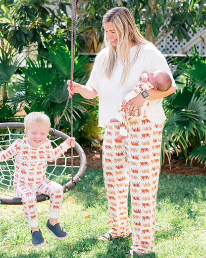 Soft white unisex Easy Tiger print pajama pants worn by a mom with her kids, matching family loungewear worn outdoors.