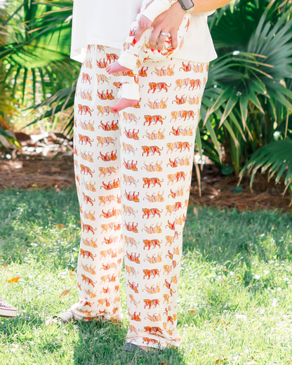 Soft white unisex Easy Tiger print pajama pants worn by a mom with her kids, matching family loungewear worn outdoors.