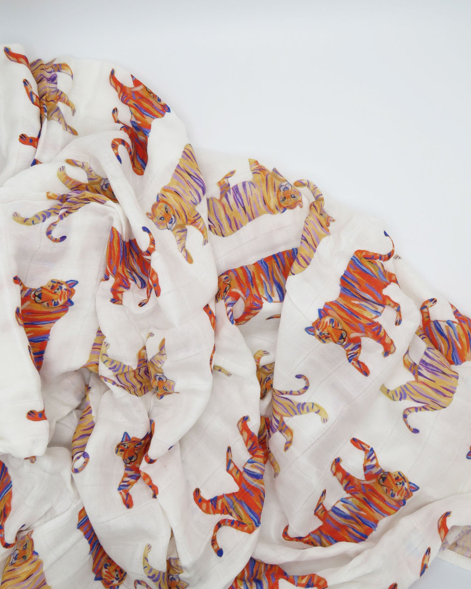 Soft and comfy Easy Tiger swaddle made from organic white cotton and bamboo, perfect for keeping a newborn cozy and comfortable during sleep or nap time.