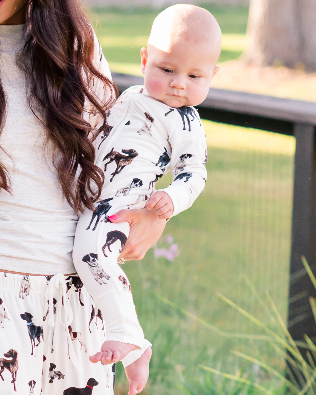 Baby wearing a bamboo zip footie with a pattern of German Shorthaired Pointers.