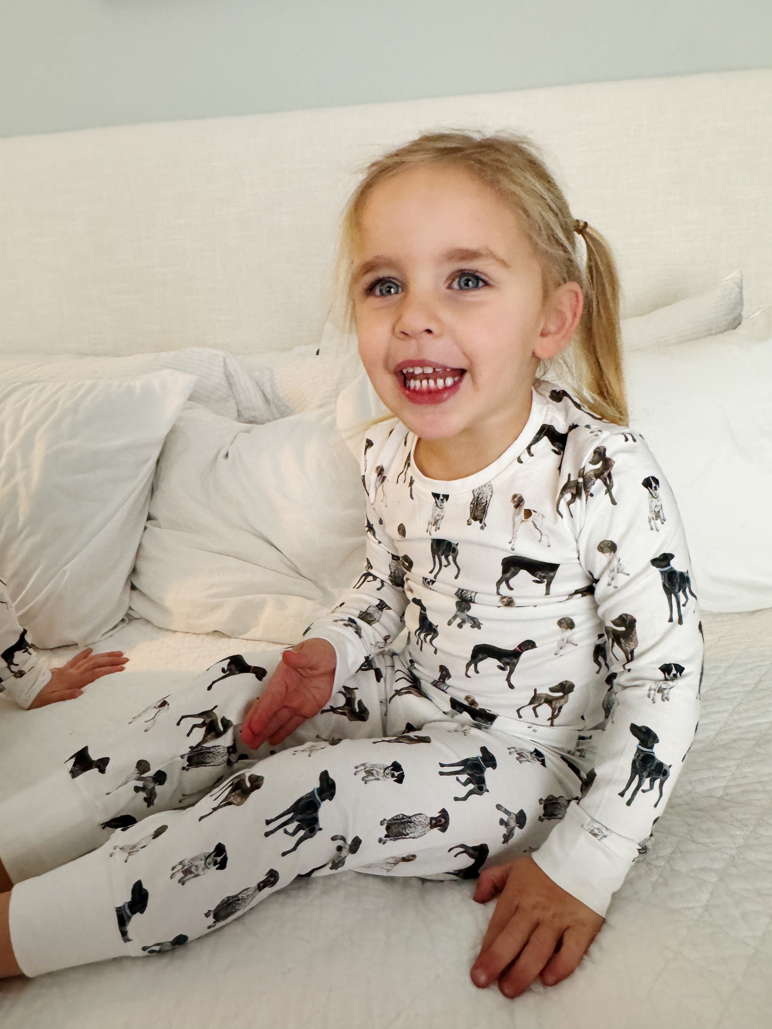 Children wearing comfy kids pajamas with German Shorthaired Pointer printed on soft white fabric