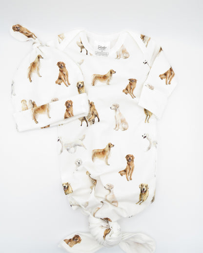Golden Retriever print newborn gown with matching hat set, featuring Golden Retrievers printed on soft white fabric.