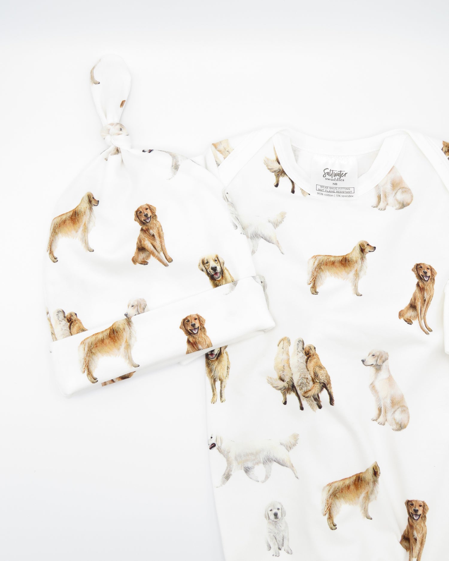 Golden Retriever print newborn gown with matching hat set, featuring Golden Retrievers printed on soft white fabric.