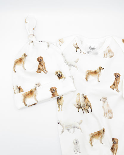 Golden Retriever print newborn gown with matching hat set, featuring Golden Retrievers printed on soft white fabric.