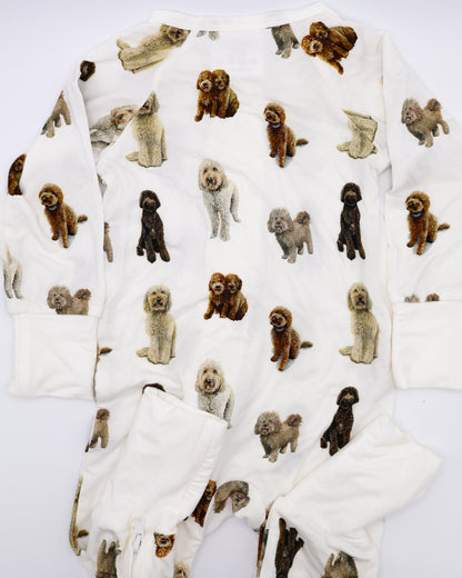 Flat-lay view of a long-sleeve goldendoodle pattern convertible zip footies, a baby romper with two-way zipper and convertible fold-over feet.